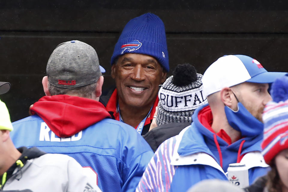 FILE - Buffalo Bills Hall of Fame running back O.J. Simpson with fans prior to an NFL football game against the Miami Dolphins, Sunday, Oct. 31, 2021, in Orchard Park, N.Y. O.J. Simpson, the decorated football superstar and Hollywood actor who was acquitted of charges he killed his former wife and her friend but later found liable in a separate civil trial, has died. He was 76. (AP Photo/Jeffrey T. Barnes, File)