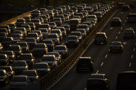 Rush hour traffic backs up along a highway in Beijing, Thursday, April 23, 2020. China says Australian calls for an independent investigation into the cause of the coronavirus outbreak are politically motivated and unhelpful in dealing with the global pandemic. (AP Photo/Mark Schiefelbein)