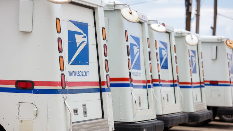 Mail trucks sit in a U.S. Postal Service parking lot in Tooele on Thursday, July 14, 2022. An extremely rare U.S. postage stamp from 1868 is up for auction.