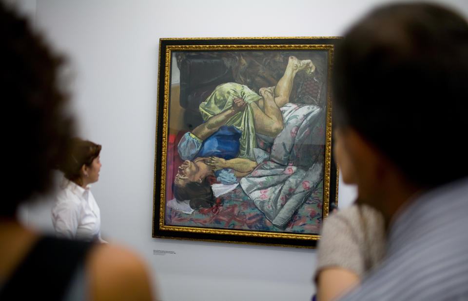 In this Sept. 14 2009 file photo, journalists look at Swallows The Poisoned Apple, a work in which Portuguese artist Paula Rego revises the tale of Snow White, during a visit to the Casa Das Historias, house of the stories, a museum dedicated to Paula Rego in Cascais, outside Lisbon. Paula Rego is one of Portugal's most famous modern artists. She fled Antonio Salazar's dictatorship, which ruled over Portugal for four decades in the last century, and settled in London in the 1950s but her work still draws powerfully on Portuguese culture and her childhood memories around Cascais, a seaside town just ouside Lisbon. (AP Photo/Armando Franca)