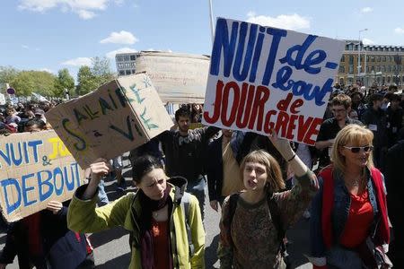 French labour union workers and students attend a demonstration against the French labour law proposal in Lyon, France, as part of a nationwide labor reform protests and strikes, April 28, 2016. The slogan reads "Nuit Debout (Up All Night), day on strike". REUTERS/Robert Pratta