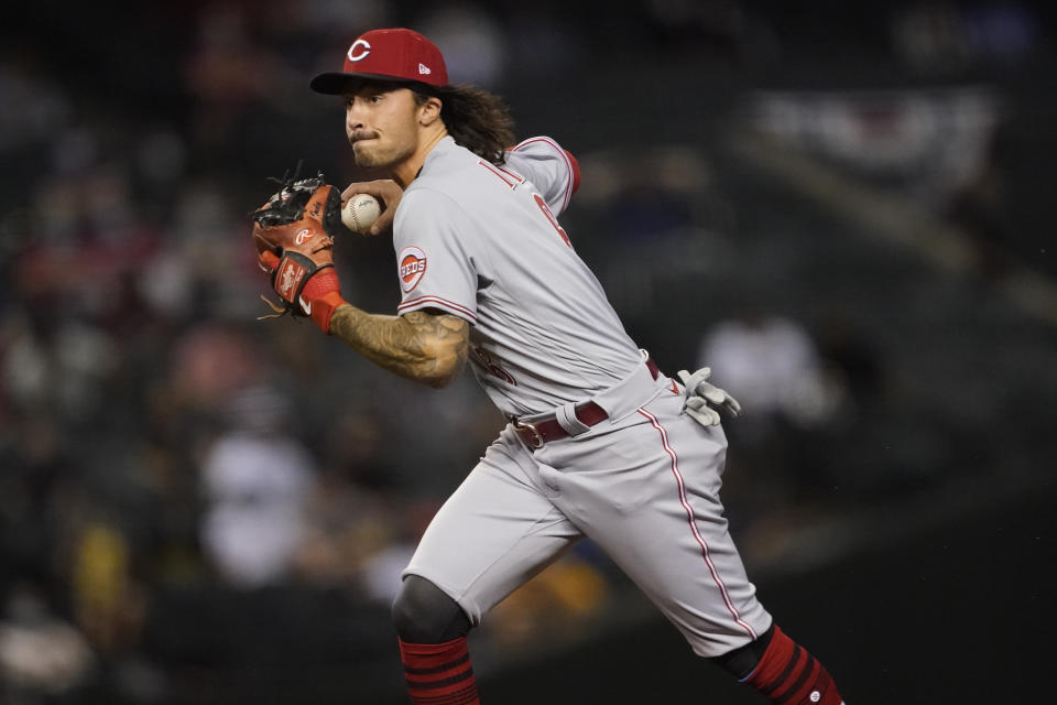 Cincinnati Reds' Jonathan India fields a ground out hit by Arizona Diamondbacks' Josh Rojas during the seventh inning of a baseball game, Friday, April 9, 2021, in Phoenix. (AP Photo/Matt York)