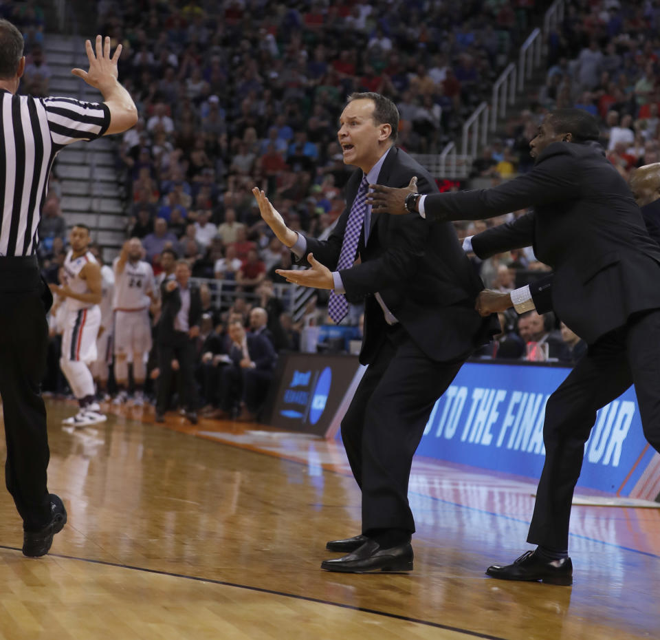 Northwestern head coach Chris Collins is held back by an assistant coach after receiving a technical foul during the second half of a second-round college basketball game against Gonzaga in the men's NCAA Tournament, Saturday, March 18, 2017, in Salt Lake City. (AP Photo/George Frey)