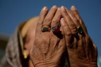 <p>A Kashmiri Muslim devotee offer prayers as a priest displays a relic at the shrine of Sheikh Abdul Qadir Geelani in Srinagar on January 22, 2016. Devotees are marking the Urs (Festival) of the saint who lived in Baghdad some 1,000 years ago and is buried there. Kashmiri Muslims hold the saint in high esteem and have set up scores of shrines and mosques in his memory. </p>