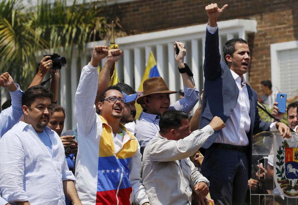 In this Saturday, March 16, 2019 photo, lawyer Roberto Marrero, left, attends a rally with Venezuelan opposition leader Juan Guaido, right, who has declared himself interim president in Valencia, Venezuela. Venezuelan security forces detained Marrero, a key aide to Guaido in a raid on his home early Thursday, March 21 an opposition lawmaker said. Marrero was taken by intelligence agents in the overnight operation in Caracas. (AP Photo/Fernando Llano)