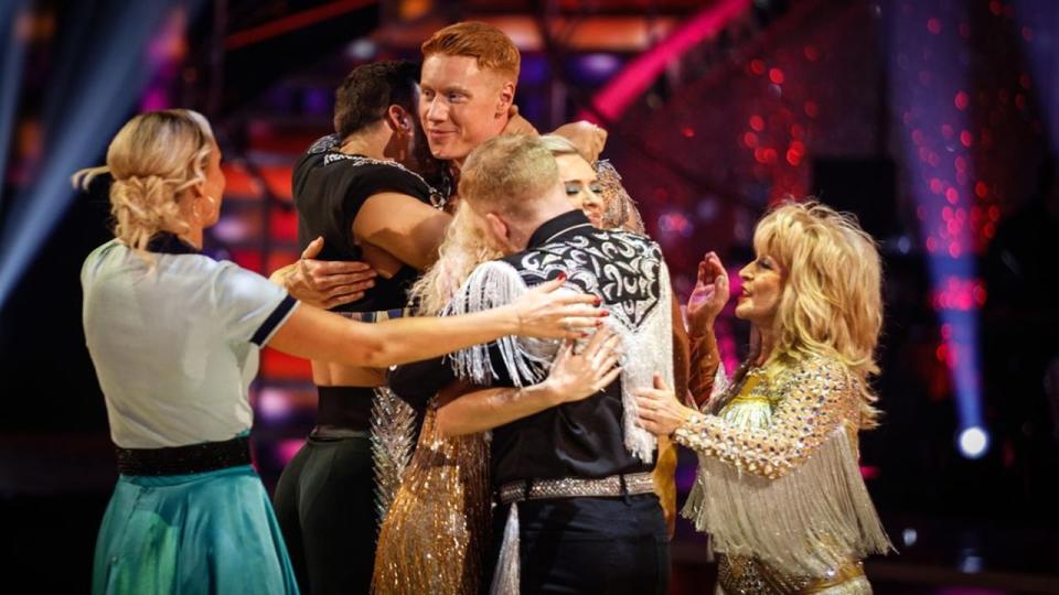 Tom Dean and Nadiya Bychkova hugged by Strictly contestants