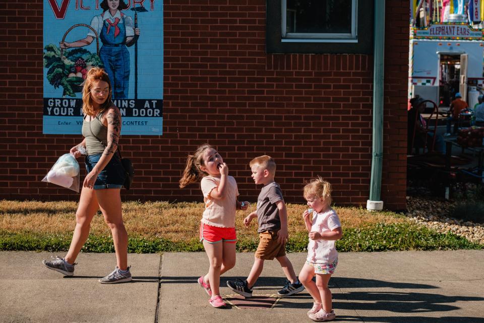 A family enjoys cotton candy during opening day of the Dennison Railroad Festival, Wednesday, May 31 in Dennison.