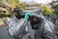 Soldiers from Royal Thai Army Chemical Department prepare to spray disinfectant as a precaution against the coronavirus at Bang Bua school in Bangkok, Thailand, Tuesday, Jan. 26, 2021. (AP Photo/Sakchai Lalit)