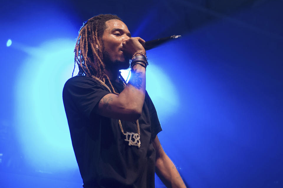 FILE - In this Saturday, Dec. 26, 2015, file photo, Rapper Fetty Wap performs in concert at Pier 36 in New York. Hip-hop promoter Raheem Thomas was arrested after a shooting Sunday, March 26, 2017, involving Fetty Wap in Paterson, N.J. Thomas is also facing an armed robbery charge, according to Passaic County prosecutors. A photo posted to Thomas' Instagram account showed a masked man wearing what appears to be Fetty Wap's signature "1738" pendant. (Photo by Scott Roth/Invision/AP, File)