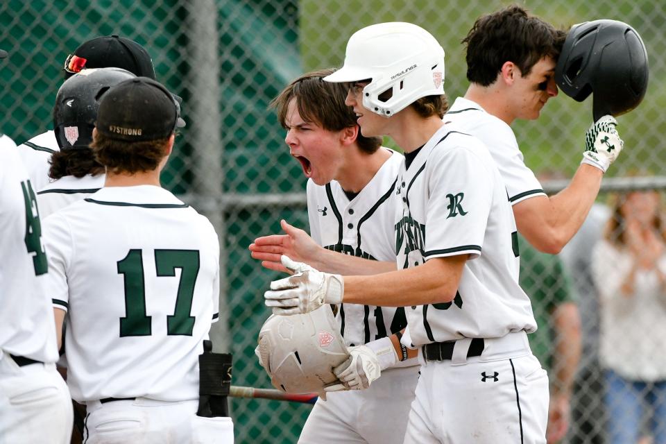 Riverside's Drake Fox (14) greets his teammates at home plate after hitting a two-run homer during Monday's game against Mohawk.