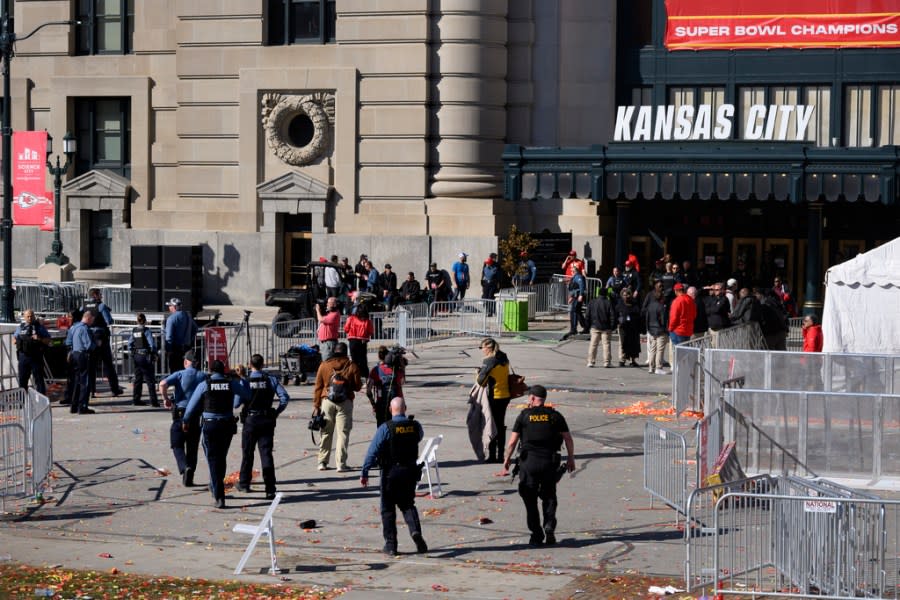 Law enforcement personnel approach Union Station following a shooting at the Kansas City Chiefs NFL football Super Bowl celebration in Kansas City, Mo., Wednesday, Feb. 14, 2024. Multiple people were injured, a fire official said. (AP Photo/Reed Hoffmann)