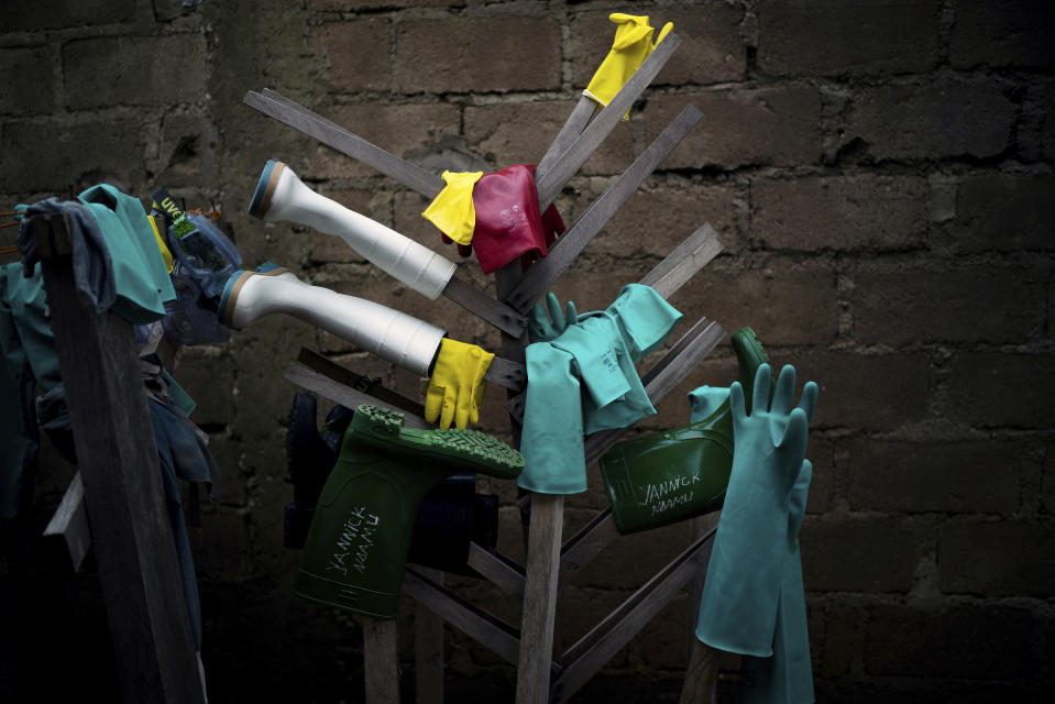 In this Friday, July 12, 2019 photo, rubber gloves and boots used by health workers treating Ebola patients are hung to dry after being disinfected at an Ebola treatment center in Beni, Congo. The World Health Organization says as many as 90 percent of those eligible for vaccination have accepted it, but that figure only includes those who gave contact tracers enough information to be included on a list. The success rate excludes those who distrusted health workers and fled, or those who couldn’t be found in the first place. (AP Photo/Jerome Delay)