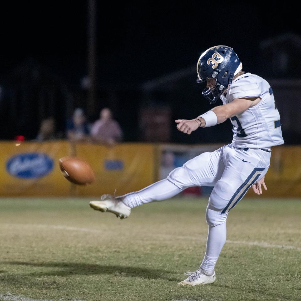 Cade Lombardo (33) punts during the Gulf Breeze vs Catholic football game at Pensacola Catholic High School in Pensacola on Thursday, Oct. 6, 2022.