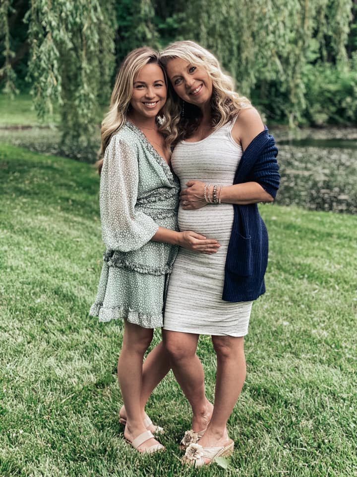 Breanna Lockwood cradles mum Julie's baby bump as Julie carries Breanna's baby as a gestational carrier