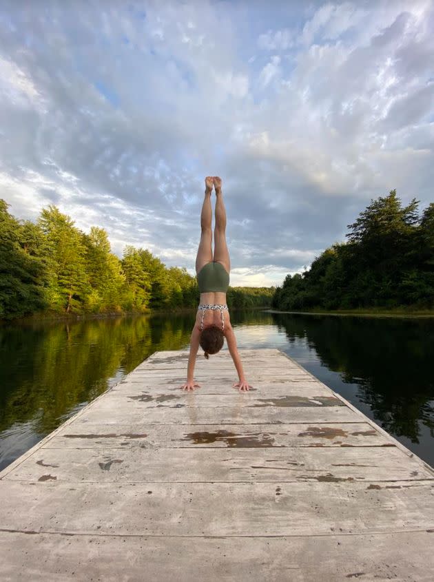 The author combining two of her favorite things: handstands and fresh water. (Photo: Courtesy of Ashlee Green)