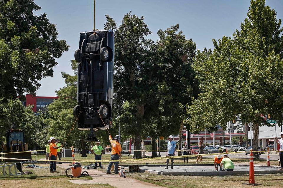 A team works Tuesday, Aug. 2, 2022, to install "Breve historia del tiempo," a sculpture by Mexican artist Gonzalo Lebrija's, at Campbell Art Park at Oklahoma Contemporary Arts Center on Automobile Alley in Oklahoma City.