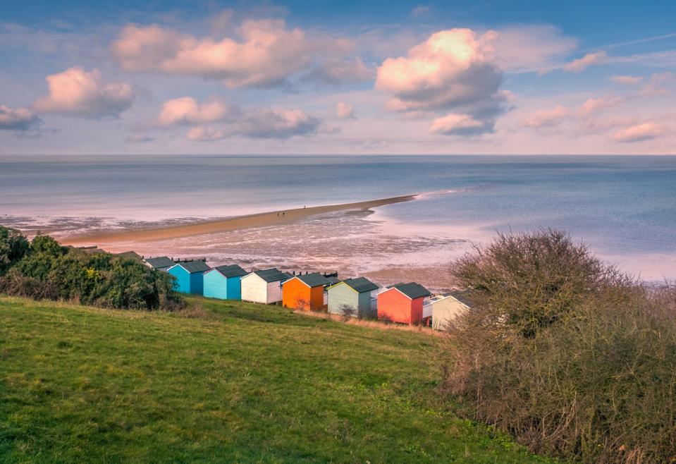 A rainbow of beach huts fringe Tankerton Beach (Getty Images/iStockphoto)