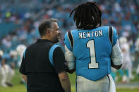 Carolina Panthers head coach Matt Rhule talks to quarterback Cam Newton (1) on the sideline after Newton came out during the second half of an NFL football game against the Miami Dolphins, Sunday, Nov. 28, 2021, in Miami Gardens, Fla. (AP Photo/Lynne Sladky)