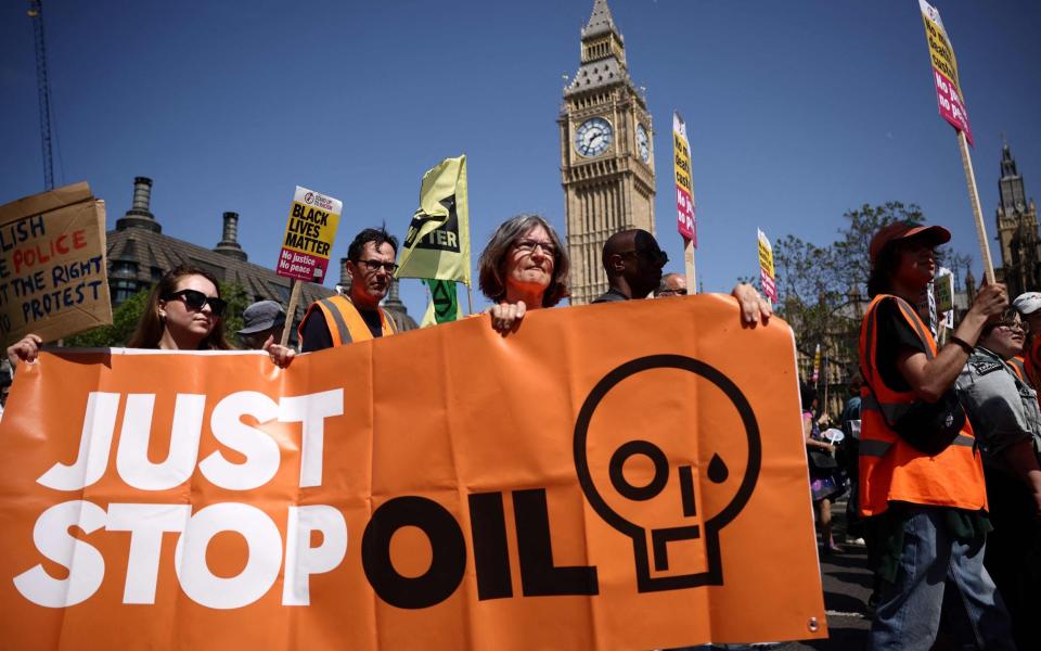 Traffic in London grinds to a halt as Just Stop Oil protesters demonstrate in front of Big Ben the Palace of Westminster - HENRY NICHOLLS/HENRY NICHOLLS/AFP via Getty Images