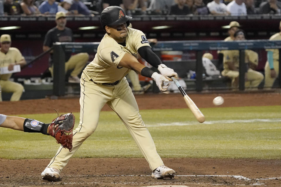 Arizona Diamondbacks' Gabriel Moreno reaches and hits a fly out against the Chicago Cubs during the fifth inning of a baseball game, Sunday, Sept. 17, 2023, in Phoenix. (AP Photo/Darryl Webb)