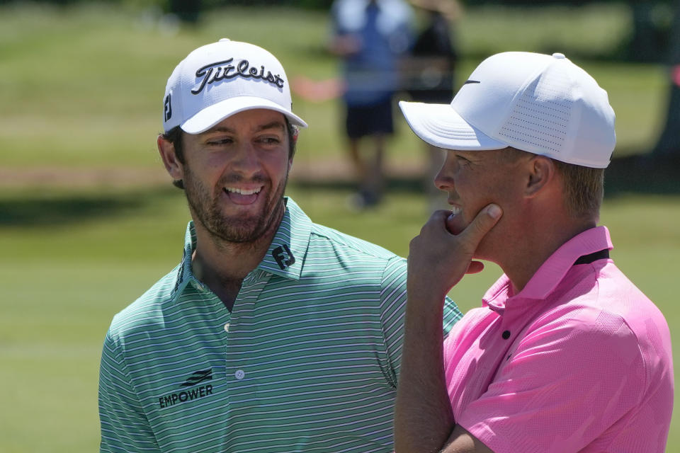 Davis Riley, left, and teammate Nick Hardy talk on the 7th green during the third round of the PGA Zurich Classic golf tournament at TPC Louisiana in Avondale, La., Saturday, April 22, 2023. (AP Photo/Gerald Herbert)