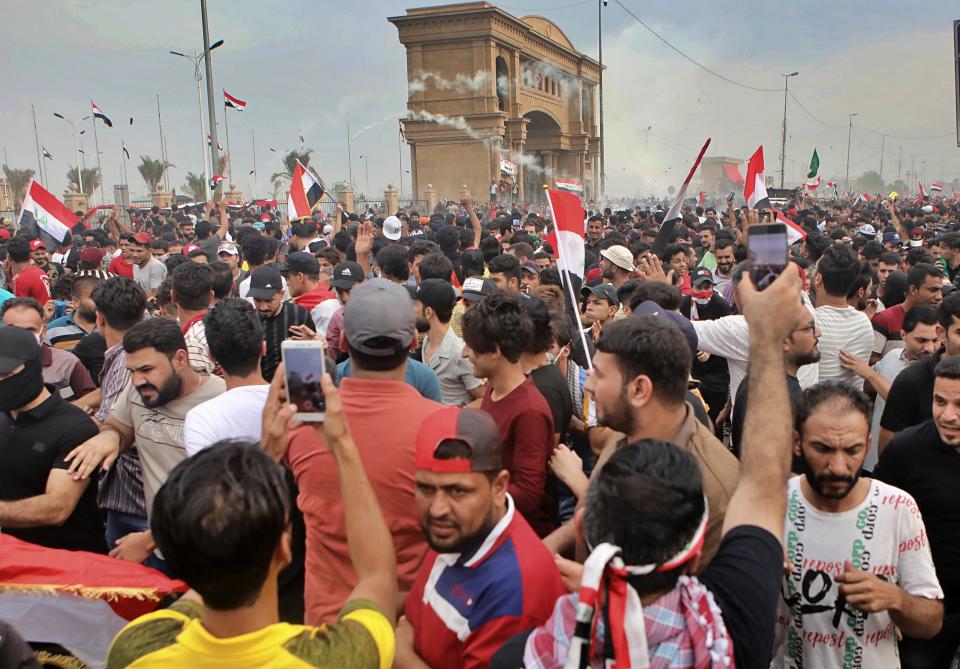 Anti-government protesters gather around the provincial council building during a demonstration in Basra, Iraq, Friday, Oct. 25, 2019. After a week of violence in the capital and the country's southern provinces, a government-appointed inquiry into the protests determined that security forces had used excessive force, killing 149 people and wounding over 3,000, and recommended the firing of security chiefs in Baghdad and the south. (AP Photo/Nabil al-Jurani)