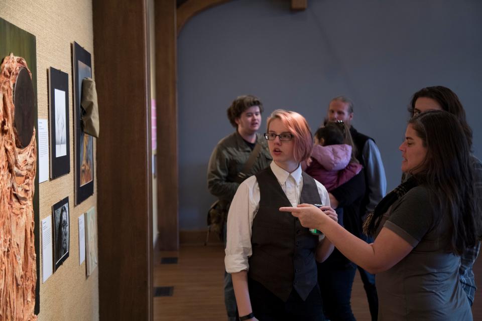 Students view the artwork on display at a Charles Allis Art Museum exhibit curated by Rufus King High School art students in May 2018.