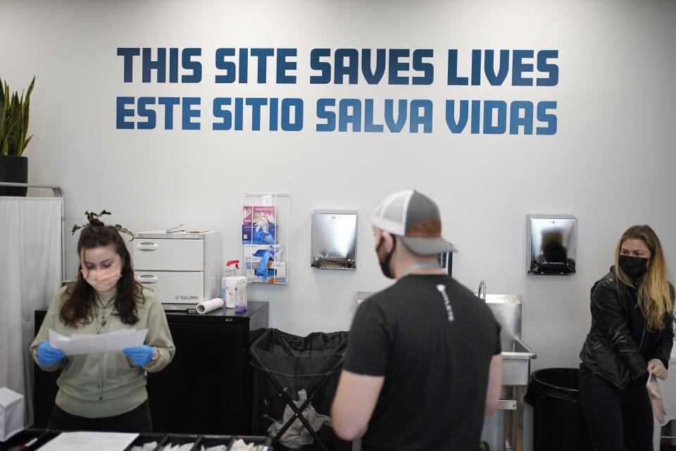 FILE - A sign on the wall reads "This site save lives" in Spanish and English at an overdose prevention center at OnPoint NYC in New York, Feb. 18, 2022. Across the U.S., drug overdoses killed an estimated 100,000 people in 2021, according to federal health officials. That has pushed lawmakers in Colorado, New Mexico and Nevada to consider joining New York in allowing what are often called “overdose prevention centers" — spaces where people can use illicit drugs under the supervision of trained staff who could reverse an overdose if necessary. (AP Photo/Seth Wenig, File)