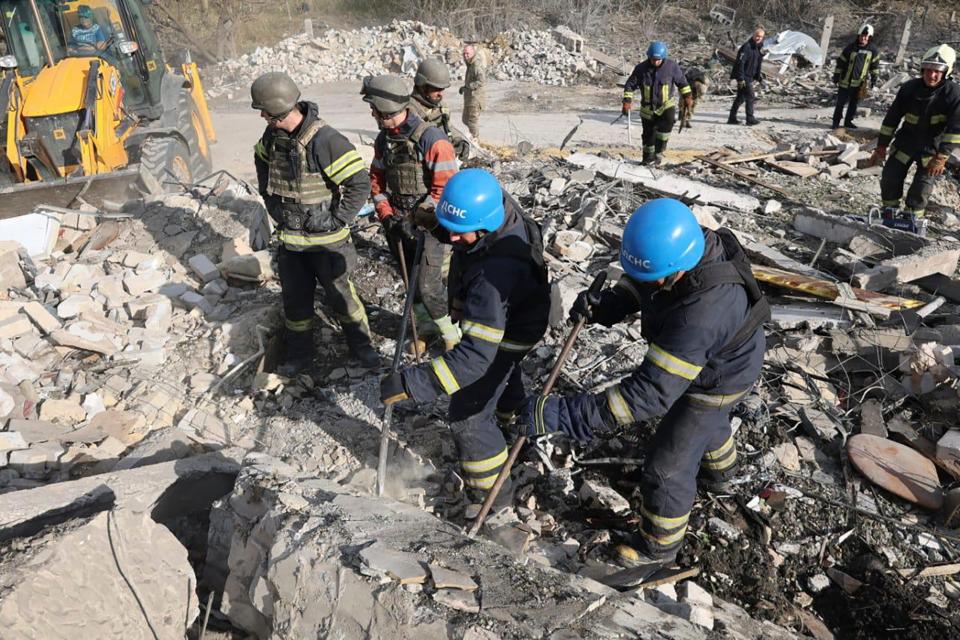 Emergency workers search for victims of the deadly Russian rocket attack that killed more than 50 people in the village of Hroza (Ukrainian Police Press Office)