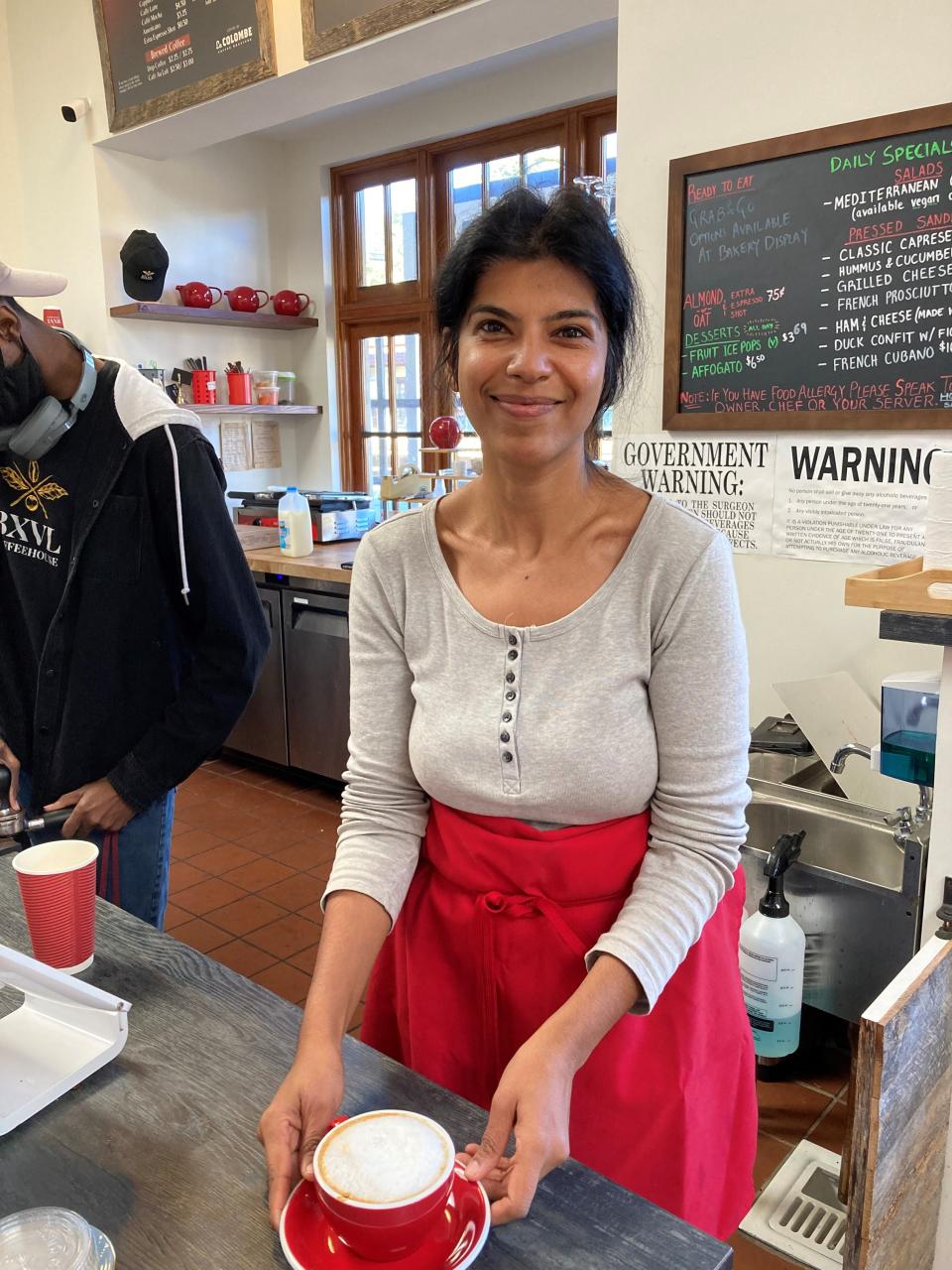 Charu Hugel Rana, owner of BXVL Coffeehouse in Bronxville, with a freshly brewed latte. Photographed Nov. 1, 2021.