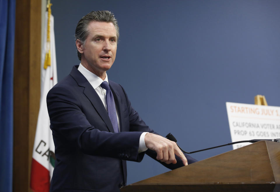 Gov. Gavin Newsom discusses a 2016 voter-approved ballot initiative that will require Californians to undergo criminal background checks every time they buy ammunition starting July 1 during a news conference in Sacramento, Calif., Tuesday June 25, 2019. (AP Photo/Rich Pedroncelli)