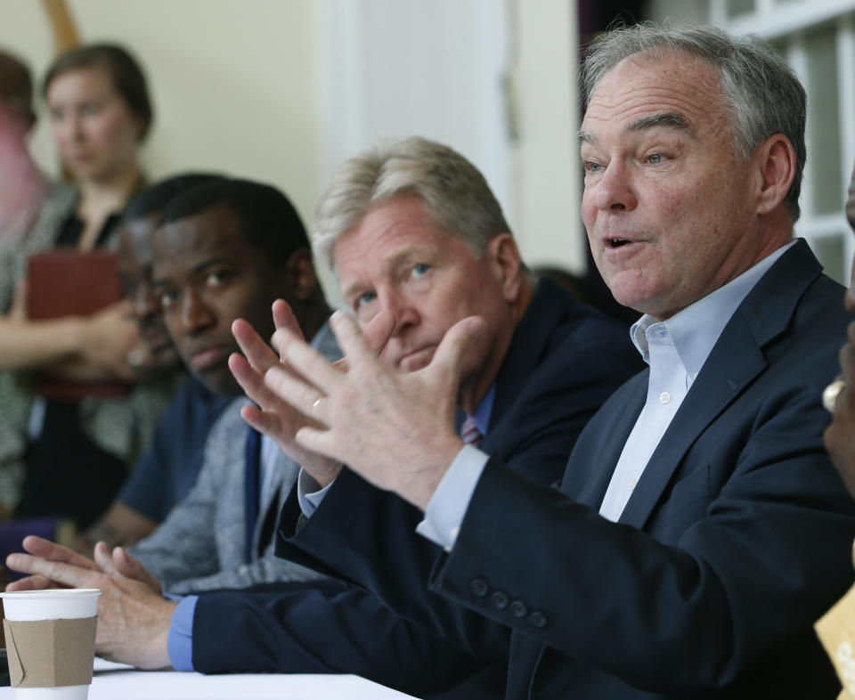 U.S. Sen. Tim Kaine, D-Va., right, gestures during a gun violence prevention roundtable discussion along with Richmond Mayor Levar Stoney, left, and Virginia Secretary of Public Safety, Brian Moran, center, in Richmond, Va., Monday, June 17, 2019. (AP Photo/Steve Helber)