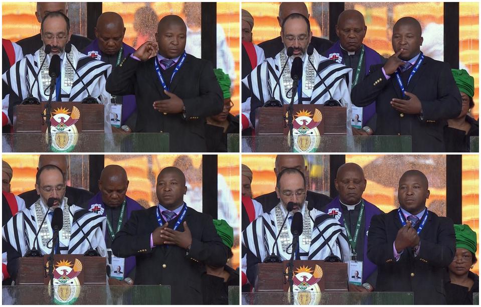 Chief Rabbi of South Africa Warren Goldstein (L) speaks alongside a man passing himself off as a sign language interpreter (R) during a national memorial service for former South African President Nelson Mandela at the First National Bank (FNB) Stadium, also known as Soccer City, in Johannesburg, in this still image taken from video shot December 10, 2013, courtesy of the South Africa Broadcasting Corporation (SABC). The fake sign language interpreter took to the stage during the memorial for anti-apartheid leader Nelson Mandela, gesticulating gibberish before a global audience of millions and outraging deaf people across the world. While dignitaries were addressing the crowd in the 95,000-seat Soccer City stadium, the young, suited man with an official security pass round his neck produced a series of hand signals that experts said meant absolutely nothing. (REUTERS/SABC via Reuters TV)