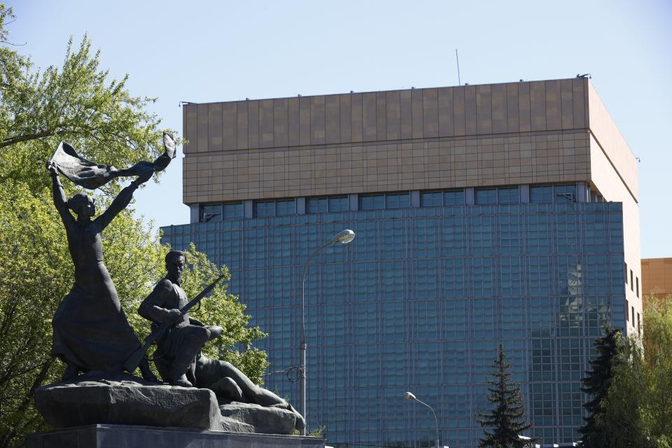 The U.S. Embassy is seen behind a monument to the Revolution workers of 1905 Revolution in Moscow, Russia, Tuesday, May 11, 2021. Under Kremlin orders, the U.S. Embassy has stopped employing Russians, leaving Russian businessmen, lovers and exchange students adrift because they can't get visas and American parents unable to register their newborns as citizens. (AP Photo/Alexander Zemlianichenko)