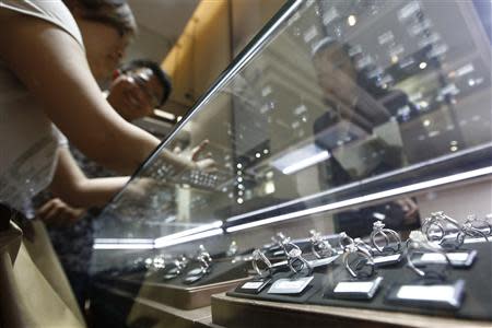 A couple selects diamond rings at a Tiffany store in Shanghai, September 16, 2013. REUTERS/Aly Song