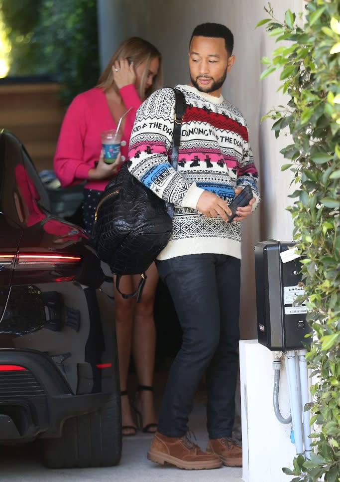 John Legend carrying a luxury black croc-embossed backpack. - Credit: MEGA