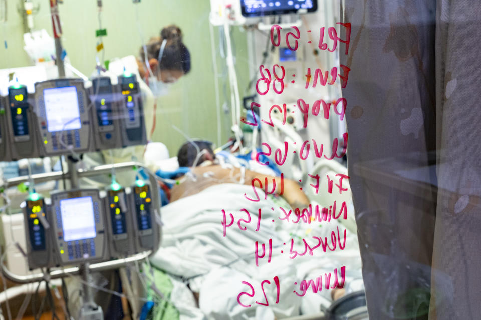 Ann Enderle R.N. checks on a COVID-19 patient in the Medical Intensive care unit (MICU) at St. Luke's Boise Medical Center in Boise, Idaho on Tuesday, Aug. 31, 2021. There are only 4 open ICU beds available in all of Idaho as of Tuesday. (AP Photo/Kyle Green)