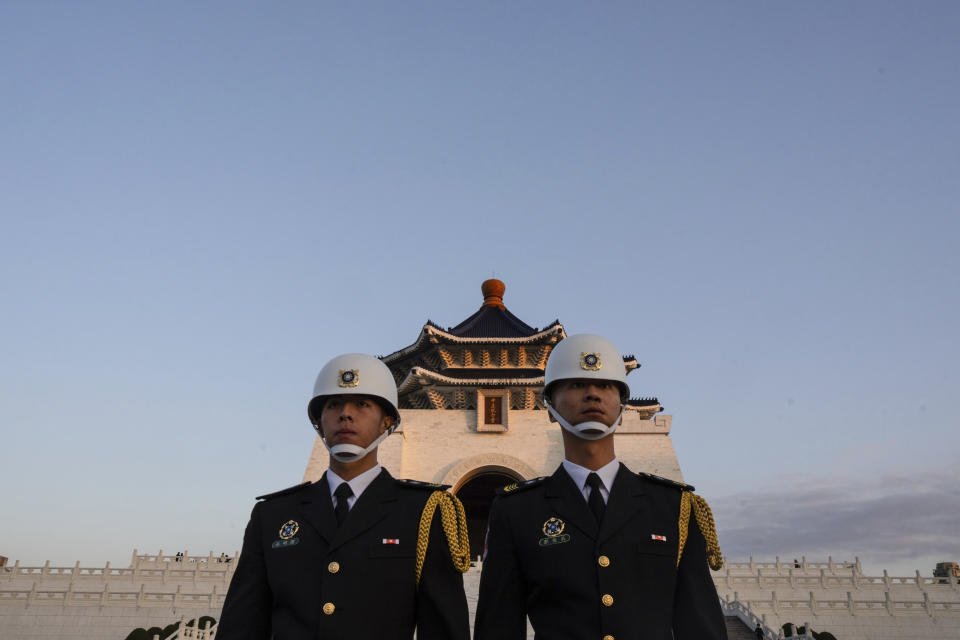 Honor guards take part in a flag lowering ceremony at Chiang Kai Shek Memorial Hall in Taipei, Taiwan on Friday, Jan. 12, 2024 ahead of the presidential election on Saturday. (AP Photo/Louise Delmotte)