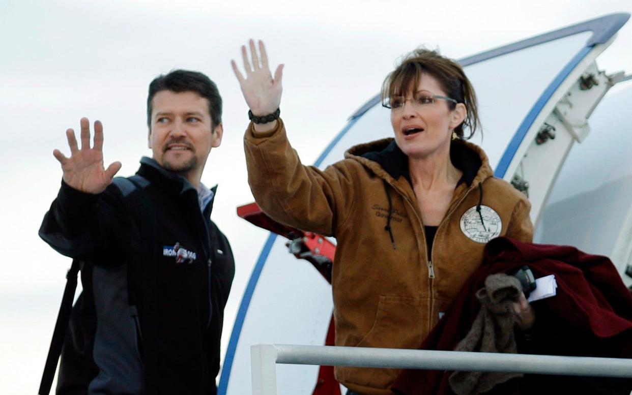 Bye, bye: Sarah Palin her husband Todd wave as they leave Anchorage International Airport bound for Wasilla, Alaska to vote in the 2008presidential election - AP