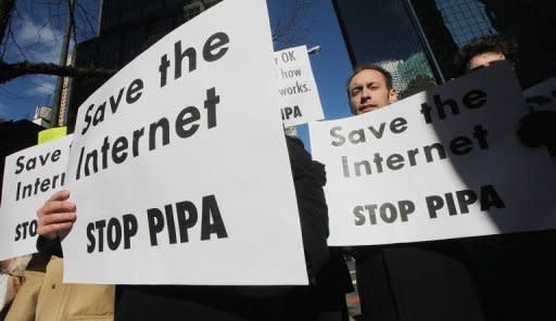 Protesters demonstrate against the proposed Stop Online Piracy Act (SOPA) and Protect IP Act (PIPA) in New York City on January 18. US Senate majority leader Harry Reid said Friday that he was delaying next week's scheduled vote on a controversial bill aimed at cracking down on online piracy