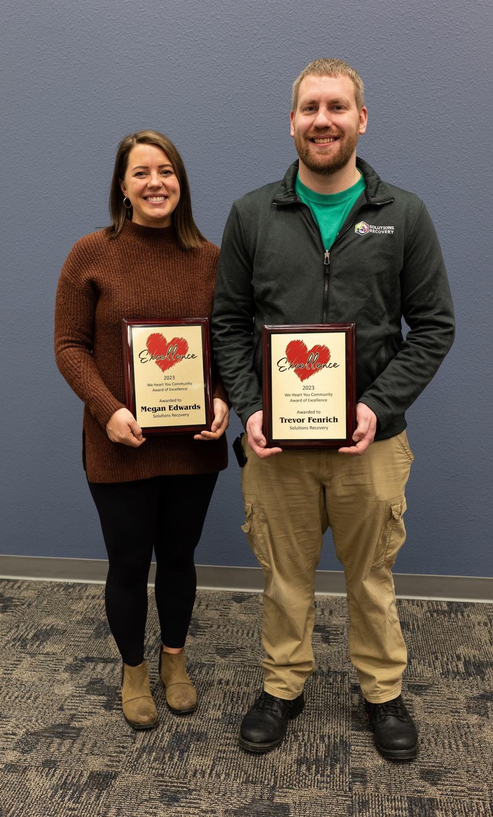 Program director Megan Edwards and executive director Trevor Fenrich of Solutions Recovery show off their We Heart You Celebration of Excellence awards.