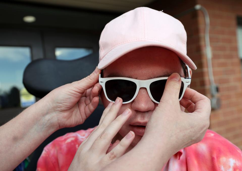 Jennifer May puts sunglasses on her son Stockton, 21, while visiting him at the Utah State Developmental Center, where he lives, in American Fork on Monday, May 1, 2023. Stockton has Dravet syndrome, a severe form of epilepsy. | Kristin Murphy, Deseret News