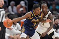 Notre Dame guard Markus Burton (3) drives against Wake Forest guard Kevin Miller (0) during the first half of the Atlantic Coast Conference second round NCAA college basketball tournament game Wednesday, March 13, 2024, in Washington. (AP Photo/Susan Walsh)