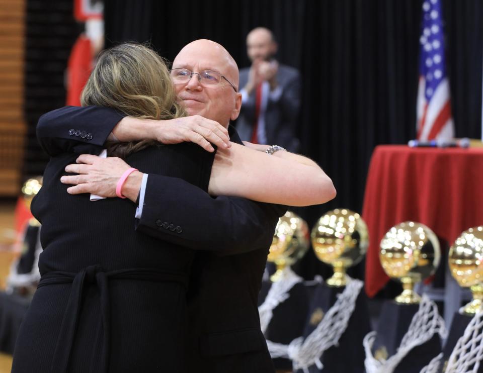 Marist College women's basketball head coach Brian Giorgis embraces assistant coach Erin Doughty speaks during Wednesday's press conference announcing Giorgis' retirement on March 2, 2022. Doughty will take over as head coach following the 2022-2023 season. 