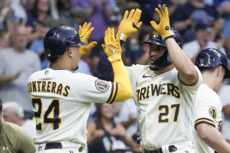 Milwaukee Brewers' Willy Adames celebrates with William Contreras (24) after hitting a two-run home run during the first inning of a baseball game against the Minnesota Twins Tuesday, Aug. 22, 2023, in Milwaukee. (AP Photo/Morry Gash)