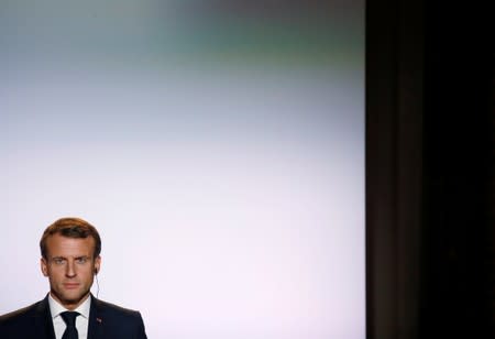 French President Emmanuel Macron looks on during a joint conference with German Chancellor Angela Merkel following a Franco-German cabinet meeting in Toulouse