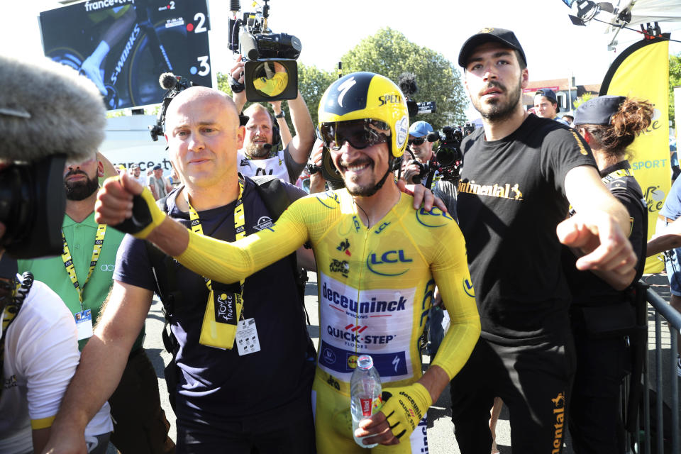 France's Julian Alaphilippe wearing the overall leader's yellow jersey celebrates after winning the thirteenth stage of the Tour de France cycling race, an individual time trial over 27.2 kilometers (16.9 miles) with start and finish in Pau, France, Friday, July 19, 2019. (AP Photo/Thibault Camus)