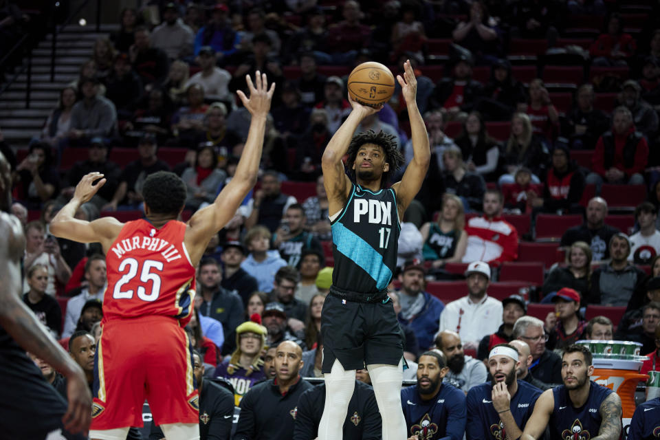 Portland Trail Blazers guard Shaedon Sharpe, right, shoots over New Orleans Pelicans guard Trey Murphy III during the first half of an NBA basketball game in Portland, Ore., Monday, March 27, 2023. (AP Photo/Craig Mitchelldyer)