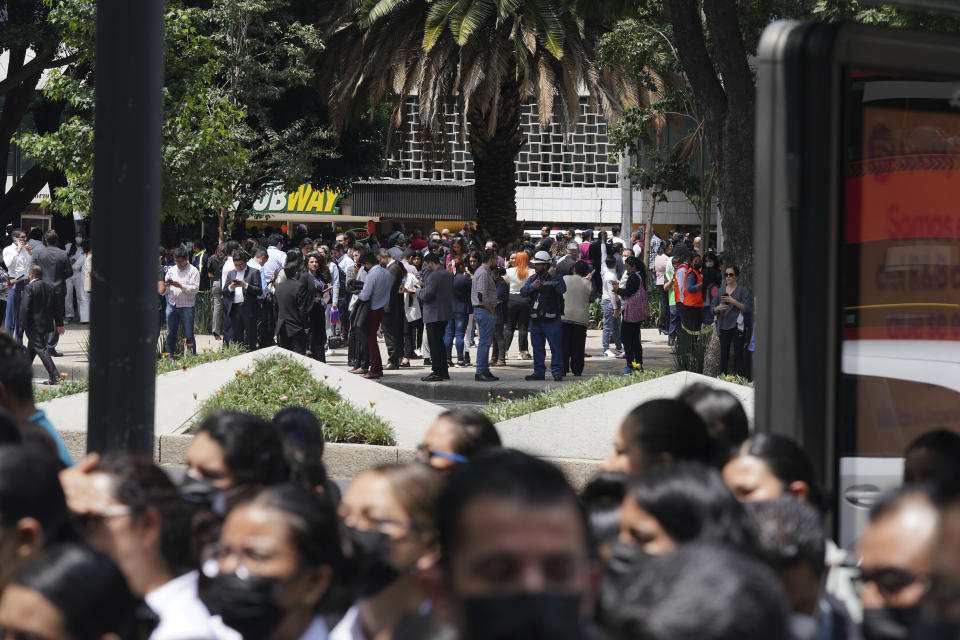 People gather outside after a magnitude 7.6 earthquake was felt in Mexico City, Monday, Sept. 19, 2022. There were no immediate reports of damage from the quake that hit at 1:05 p.m. local time, according to the U.S. Geologic Survey, which said the quake was centered near the boundary of Colima and Michoacan states. (AP Photo/Fernando Llano)