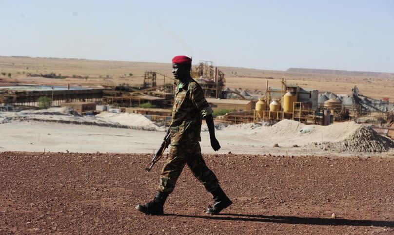 A Nigerien soldier walks outside France&apos;s state-owned nuclear giant Areva&apos;s uranium mine, September 2010